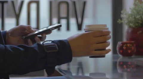 Young girl texting a message while sipping coffee indoors Stock Footage 67051941