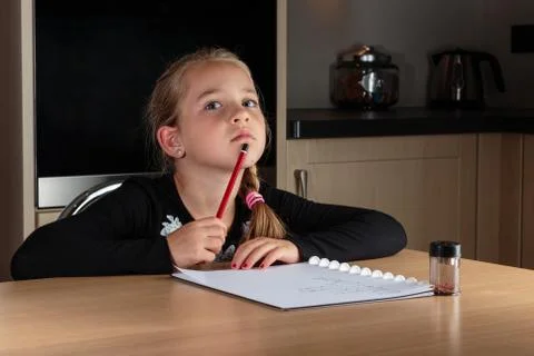 Young girl thinking while doing homework Stock Photos