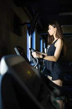 Young girl trainer performs exercise in modern gym club Stock Photos