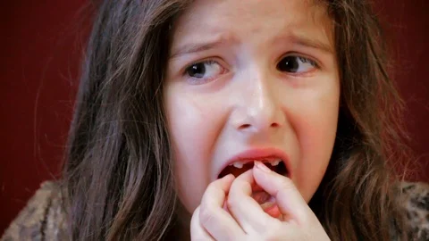Young Girl Tries To Pull Tooth Painful Video stock 96464010