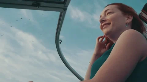 Young girl in turquoise dress drive motor boat. Summer evening. Wind. Blue sky Stock Footage