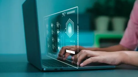 A young girl is typing a code to access a laptop computer , Stockfoto's