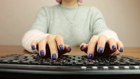 Young girl typing on a computer keyboard Stock Footage 219213148