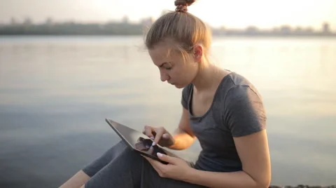 Young girl is typing a message on a tablet Stock Footage 66554564