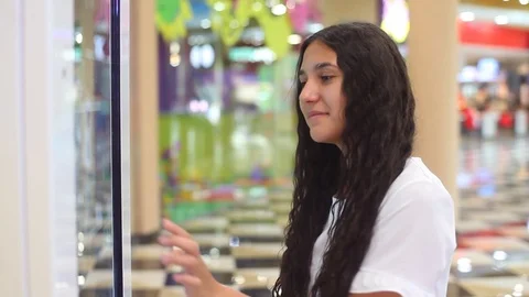 Young Girl uses an interactive panel while making an online purchase at the mall Video stock 90771009