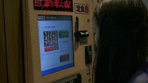 Young girl using automated ordering machine Stock Footage