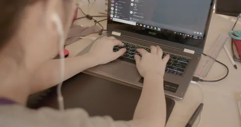 Young girl using her laptop computer Stock Footage 131908276