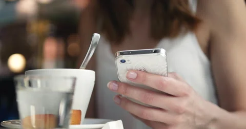 Young girl using her mobile phone in Cafe 4K Stock Footage 51685007