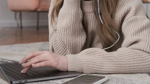 Young girl using laptop for work in modern apartment. Video stock 125464640