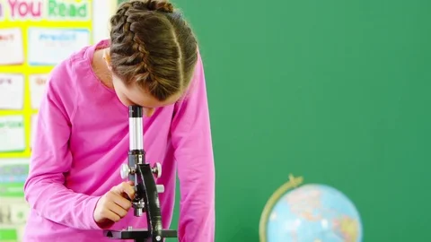 Young girl using microscope Stock Footage 80131516