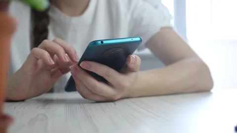 Young girl using mobile phone, checking fo the new notification and left smartph Stock Footage 163340254