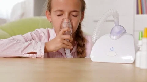 Young girl using nebuliser inhaler with mask Stock Footage 80353820