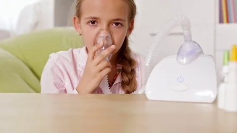 Young girl using nebuliser inhaler with mask Stock Footage 80360354