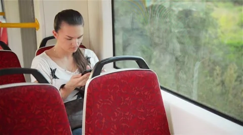 Young girl using smart phone during bus ride, Beautiful woman travelling Stock Footage 65123082