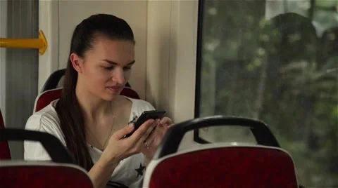 Young girl using smart phone during bus ride, Beautiful woman travelling Stock Footage 65124873