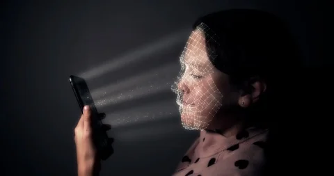 Young girl using a smart phone and unlocking it with a facial recognition scan Stock Footage