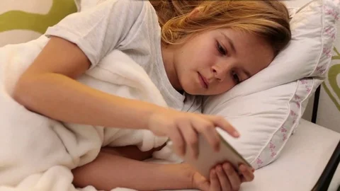 Young girl using smartphone in bed Video stock 80241898