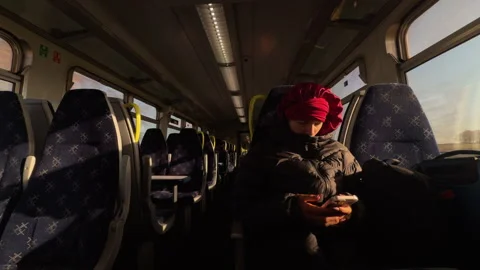 Young Girl Using Smartphone Inside Empty Moving Train Carriage Video stock 336923544