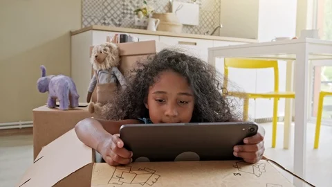 Young girl using tablet computer at kitchen table, front view Stock Footage 119861005