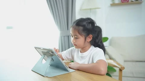 Young girl using tablet for learning and creativity at home, engaged in edu.. 스톡 동영상 333612092