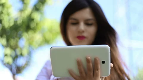 Young girl using tablet in park Video stock 54933376