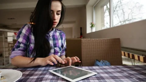 Young girl using tablet pc in the restaurant. Stock Footage 61407560