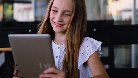 Young girl using tablet pc in cafe and smiling Video stock 93306378
