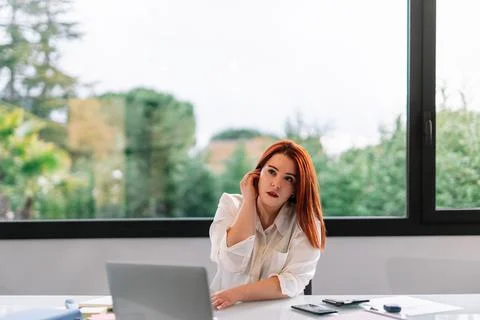 Young girl using wireless headset while working at home Stock Photos