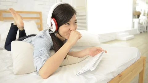 Young girl using wireless keyboard on the bed Video stock 93631549
