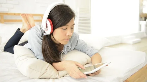 Young girl using wireless keyboard on the bed Video stock 93631645