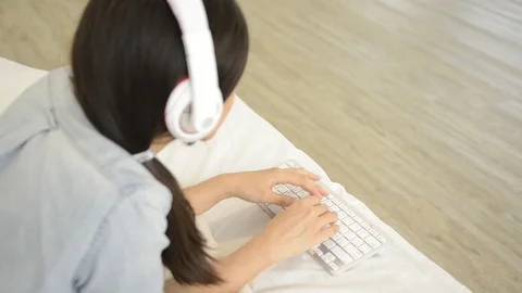 Young girl using wireless keyboard on the bed Video stock 93631982