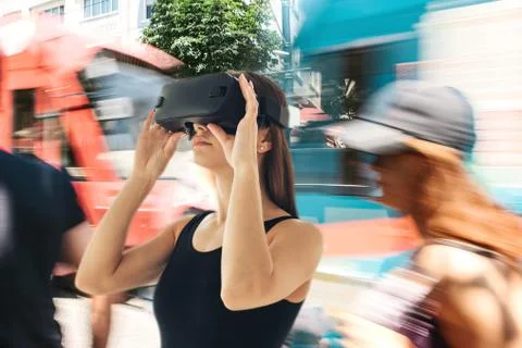 A young girl with virtual reality glasses or a virtual tourist or traveler. The Stock Photos