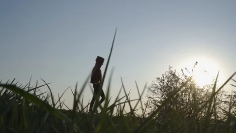 Young Girl walk downhill SUNSET/SUNRISE in background (4K) Stock Footage