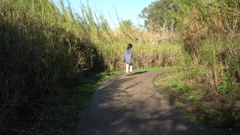 Young girl walking by herself on a pathway in the Galilee, Israel Stock Footage 170197383