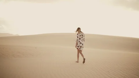 Young Girl Wandering in the Desert Sand Dunes Stock Footage