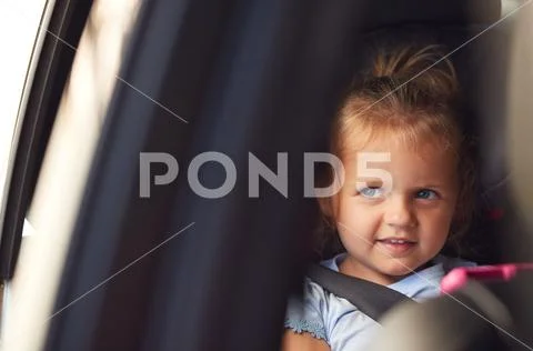 Young Girl Watching Digital Tablet In Back Seat On Car Journey Stock Photos