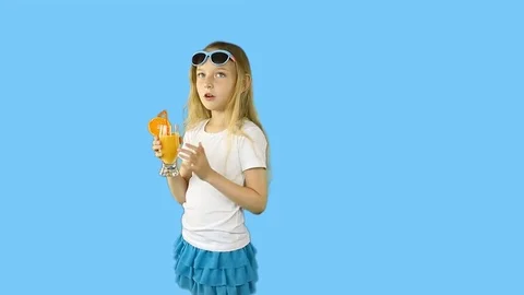 Young girl in white t-shirts flirt and drink orange juice from glass. Happy girl Stock Footage