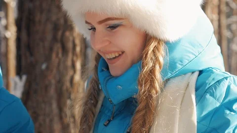 A young girl in a winter jacket drinking hot tea in the woods. Stock Footage 86571092