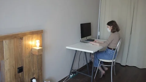 A young girl is working on a computer in her room during quarantine and then Stock Footage 127352626