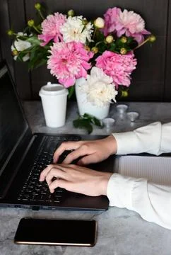A young girl is working on a computer in the office, remote work, solving eco Stock Photos