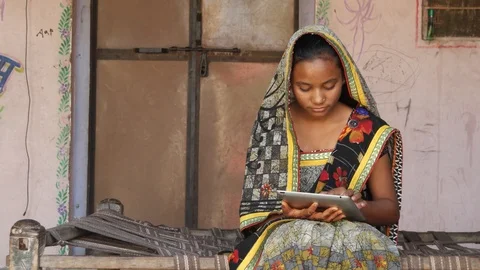 Young girl working on a touch screen tablet pad at home in a rural environment  Stock Footage 93028633