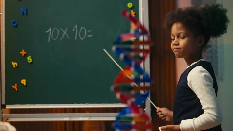 Young girl writing on chalkboard with pointer, playing classroom teacher Video stock 308002297