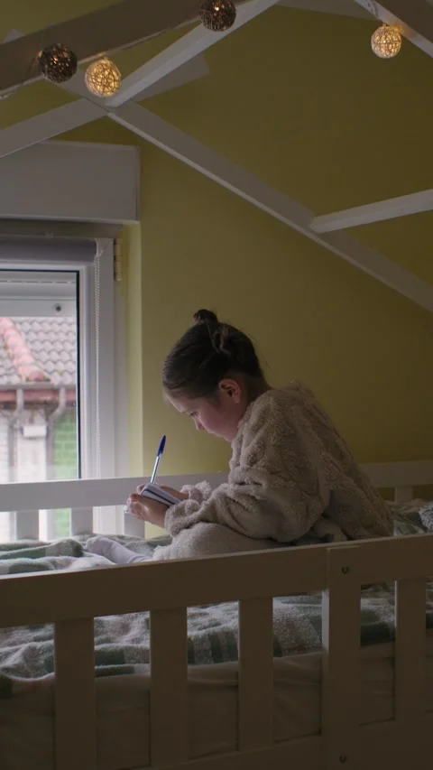 Young Girl Writing in a Notebook on a Bunk Bed Stock Footage 333238996