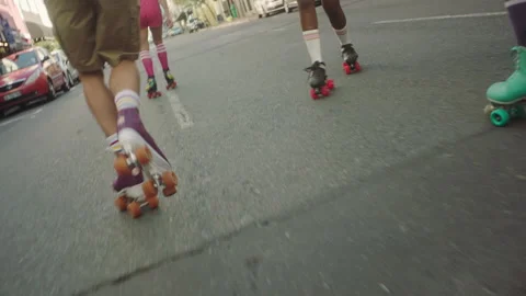 Young Girls and a guy rollerskating through the city Stock Footage 279379752