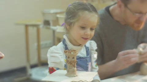 Young Girls And Man at Pottery Workshop Smiling Kid is Looking at the Other Stock Footage 59127800