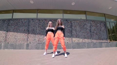 Young girls dancing dancehall twerk in the open air. Booty Dance. Gimbal shot Stock Footage 133607045