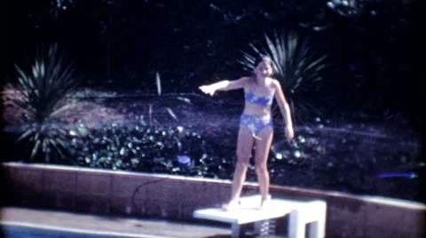 Young girls on diving board in backyard pool 1950s vintage film home movie 3570 Stock Footage 67331209
