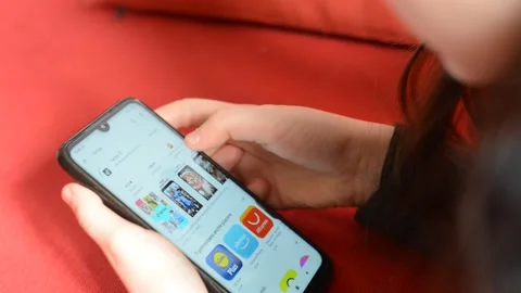 Young girl's hands using smartphone to installa Tik Tok app Stock Footage 147547874