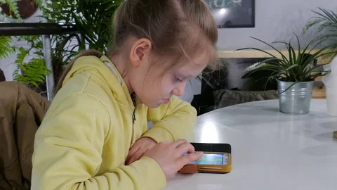 Young girls with her smartphone. Children with smart phone Stock Footage