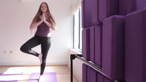 Young girls practicing yoga with instructor, standing in Virabhadrasana exercise Stock Footage 186978828